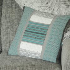 Pillow built in textured stripes and natural colors.