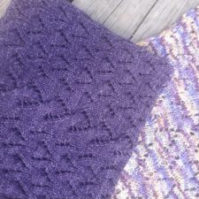 Cable and lace cowl shown in solid color and coordinated variegated version.