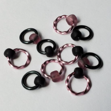 Captured bead markers with matte finish beads. Rings and beads are pink or black, with all combinations shown. Pink rings are twisted metal.