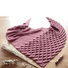 Triangular shawl is crocheted solid for half and with fish scale-like texture for the other half.
