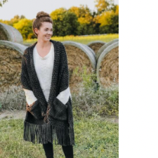 Long fringed bulky stole in garter stitch. Large stockinette pockets are trimmed with a top band of garter stitch.