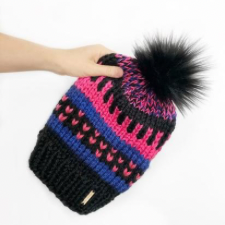 Chunky hat in three colors, featuring colorwork stripes, including one that resembles a piano keyboard.