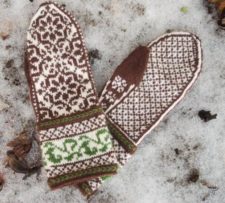 Traditional colorwork mittens with intricate geometric patterns throughout and a vine on the cuffs.