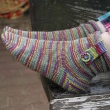 Striped sock with foldover strap at cuff, secured with Dorset button.