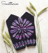 Dark mittens with flower design that extends across both mitten tops.