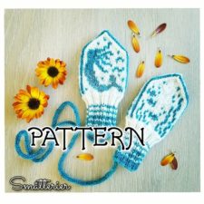 Baby mittens on a string, with colorwork mermaid on one and undersea plants on the other.