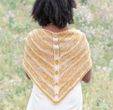 Triangular shawl with phases of the moon in colorwork down the spine.