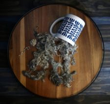 Natural locks spilling out of coffee cup.