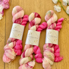 Variegated pink and cream skein with bright pink mini skein