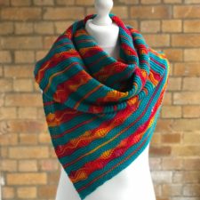 Small triangular shawl in stripies with yarnover openwork in some of the stripes.