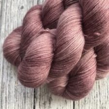 Semi-solid yarn in a faded rose color.