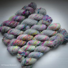 Silver yarn with sparkles and a few colorful speckles.