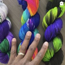 Three bright variegated skeins. Royal Earth is purples and greens. Glow is very bright in several shades, and Malice is neon green and purple.