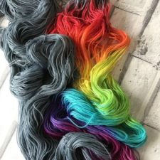 Skeins are half stormcloud color and half rainbow gradient.