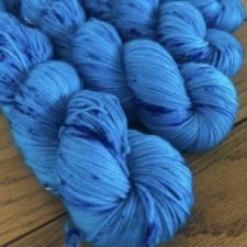 Bright blue yarn with deeper bright blue speckles.