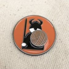 Round enamel pin with Viking.