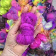 Large pile of small bundles of bright spinning fiber.