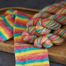 Medium-tone self-striping yarn that knits up to socks with half-inch stripes.