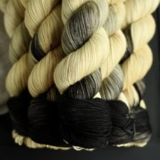 Variegated yarn in palest yellow to deep black.