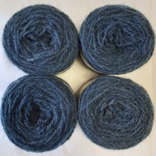 Four yarn cakes the color of blue jeans.