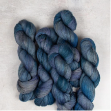 Swirly variegated yarn in cool colors.