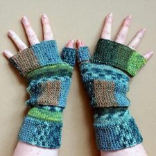 Fingerless mitts in a patchwork of colors using garter stitch.