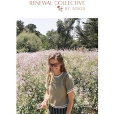 Woman in crew-neck tee stands in a wildflower field. Tee has textured stripes on the yoke and textured stripes in contrasting color near the cuffs.