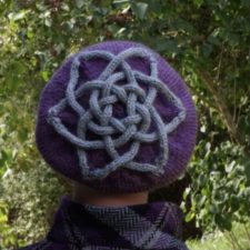 Hat with I-cord Celtic Knot affixed to it in contrasting color.