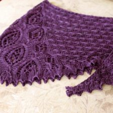 Lace shawl in two lace patterns. Bottom edge is blocked into points.