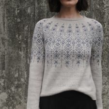 Delicate colorwork in long vertical motifs on the yoke, upper body and sleeves.