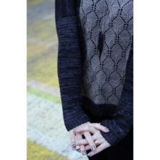 Long sleeve pullover with lace panel whose motif is shaped like wrought iron.