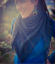 Beautiful top-down triangular shawl with openwork between sections.