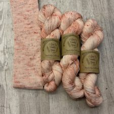 Speckled tonal yarn in warm tones, with sock tube.