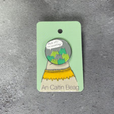 Enamel pin of cats with word balloon.
