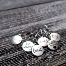 Silver disk markers with inspirational words like “Love” and “Be strong.”