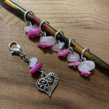 Heart charm with light and dark pink polished stones. One progress keeper and six stitch markers.