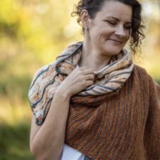 Asymmetric triangle shawl in two color panels, both striped.