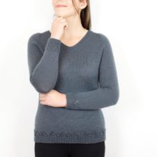 V-neck pullover with yarnover zigzag above ribbed hem.