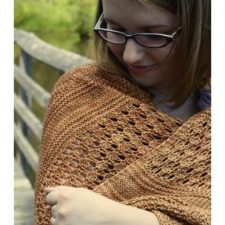 Stockinette shawl with purl rows and a lace panel.