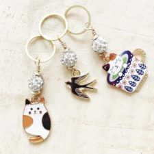 Detailed enamel charms on solid rings. Calico cat, bird and cat soaking in teacup.