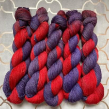 Variegated yarn that is half true red and half violet.