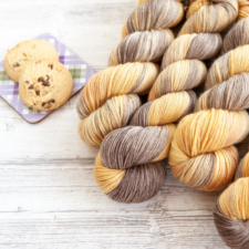 Variegated yarn next to chocolate chip cookies, which are in the same colors.