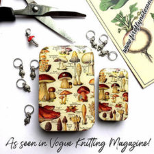 Tin with retro botanical mushroom print, and eight mushroom-shape stitch markers.