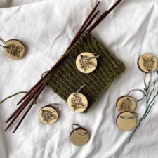 Round wooden stitch markers with detailed image of hydrangeas.