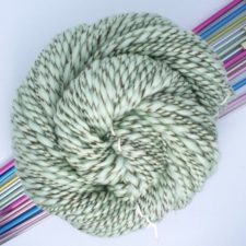 Thick and thin marled yarn in mint chocolate chip colors.