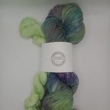 Sock set with bright green mini-skein and variegated yarn in cartoon monster colors.