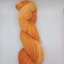 Tonal bright pumpkin color yarn.