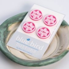Round buttons with inset lotus blossoms.