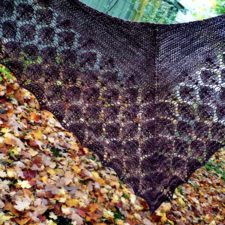 Triangular shawl, mostly leaf-motif lace. Two very similar colorways create subtle striping.