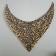 Nearly triangular shawl with brioche leaves and wide zigzag border along bottom edges.